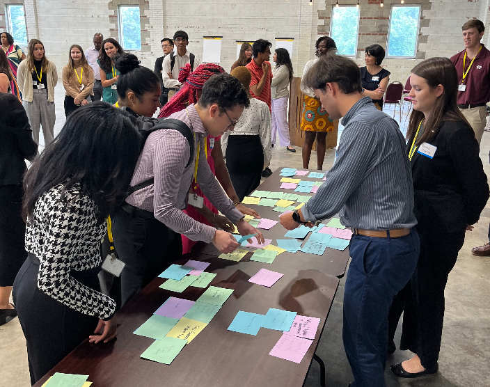 People standing around a table with post cards