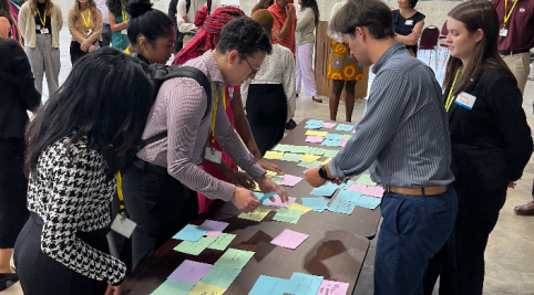 People standing around a table with post cards